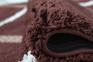 Close-up of a brown textured rug with a focus on the edge.