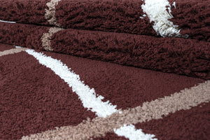 Stack of brown towels with white accents on a matching brown background