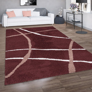 Red and white patterned rug on a wooden floor in a living room setting.