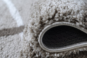 Close-up of a textured gray rug with a black border