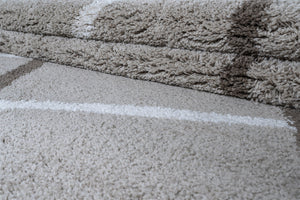 Close-up of a textured gray rug with a white line on a brown surface