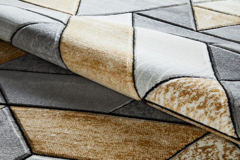 Close-up of a textured rug with geometric pattern in brown, beige, and gray.
