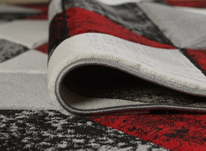 Close-up of a patterned rug with red, black, and gray colors.