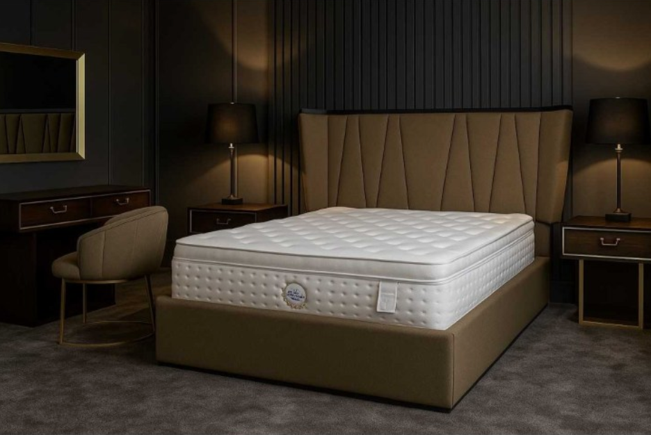 Beige mattress on a bed frame in a dimly lit bedroom setting