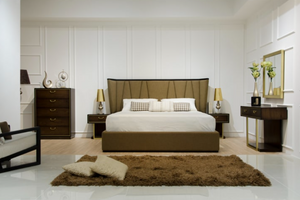 Modern bedroom with a bed, nightstands, and decorative items.