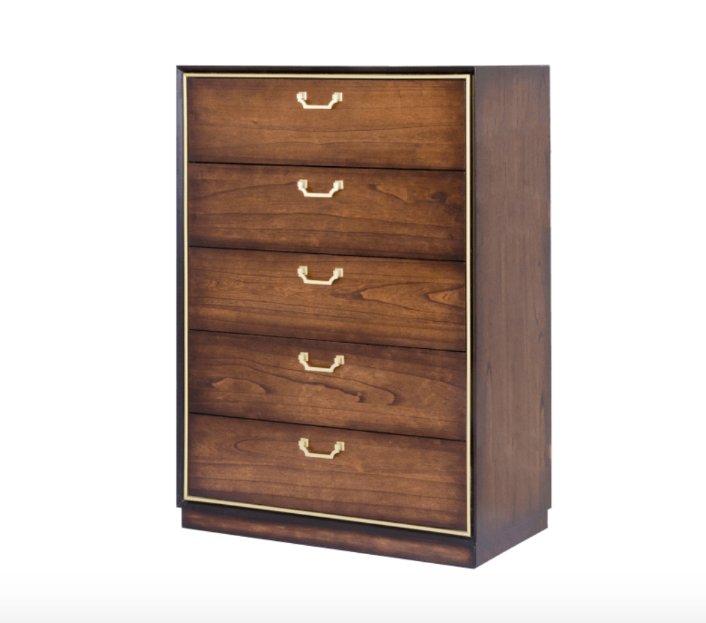 Wooden dresser with four drawers and gold handles on a white background