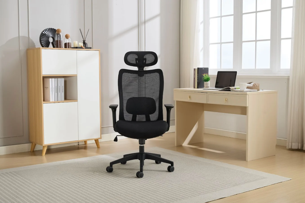 Black office chair in a modern home office setting with a desk and shelves.