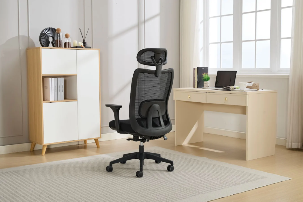 Black office chair in a modern office setting with a desk and shelves.