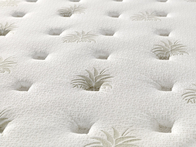 Close-up of a white mattress with tufted design