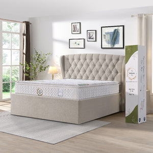 Mattress with tufted headboard and packaging in a bedroom setting