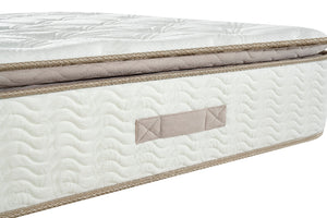 Close-up of a mattress with a brand label on a white background