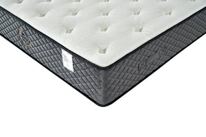 Corner of a mattress with quilted design on a white background