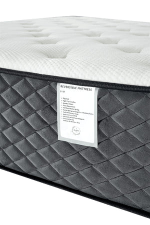 Gray and white mattress with a label on a white background