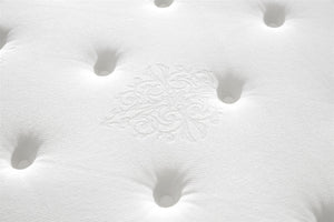 Close-up of a white mattress surface with visible stitching
