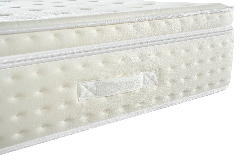 White mattress with a brand label on a white background