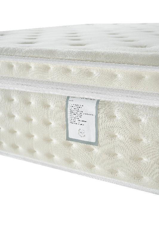 White mattress with a label on a white background