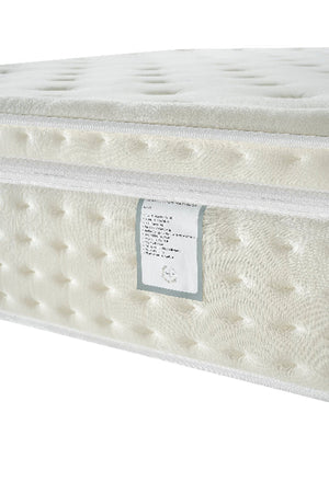 White mattress with a label on a white background
