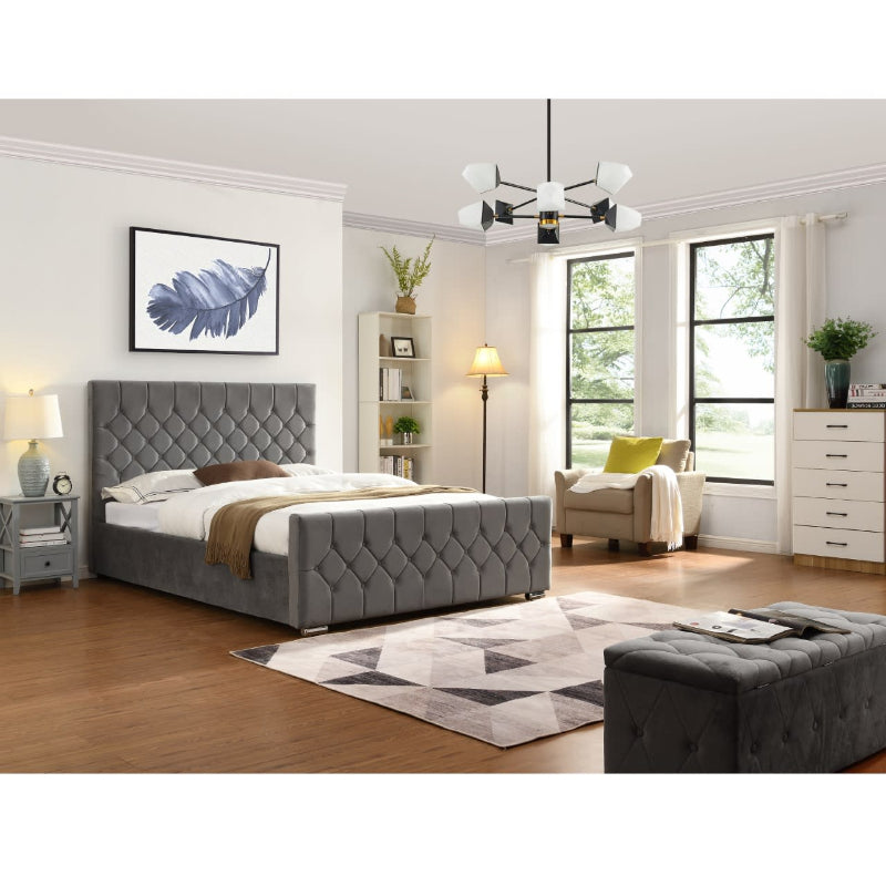 Modern bedroom with grey tufted bed, armchair, and dresser.