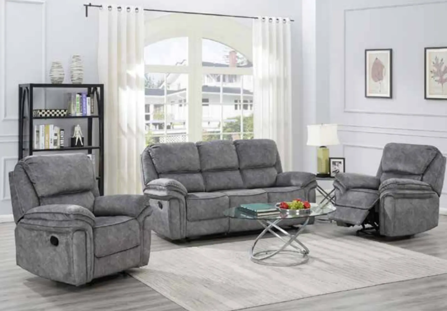 Gray reclining sofa set in a living room with a coffee table and chairs.