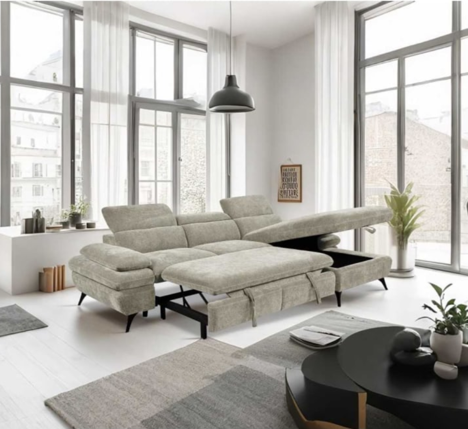 Modern living room with a beige sectional sofa, black coffee table, and large windows.