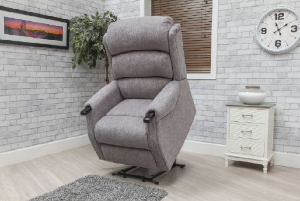 Gray recliner chair in a living room setting with a clock on the wall.