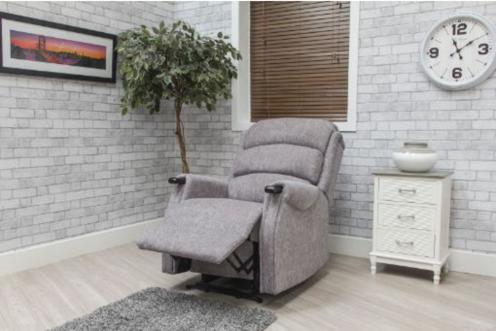 Gray recliner chair in a room with a clock, plant, and side table.