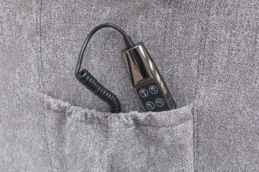 Small electronic device with coiled cable in a pocket