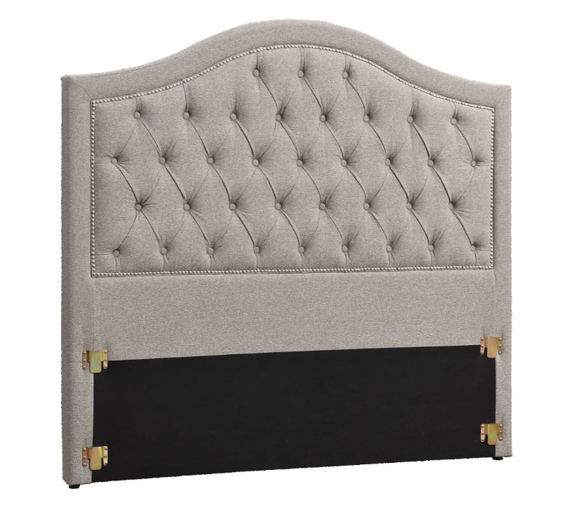 Gray tufted headboard with black base on a white background