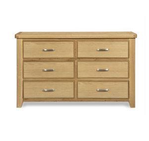 Wooden dresser with six drawers on a white background