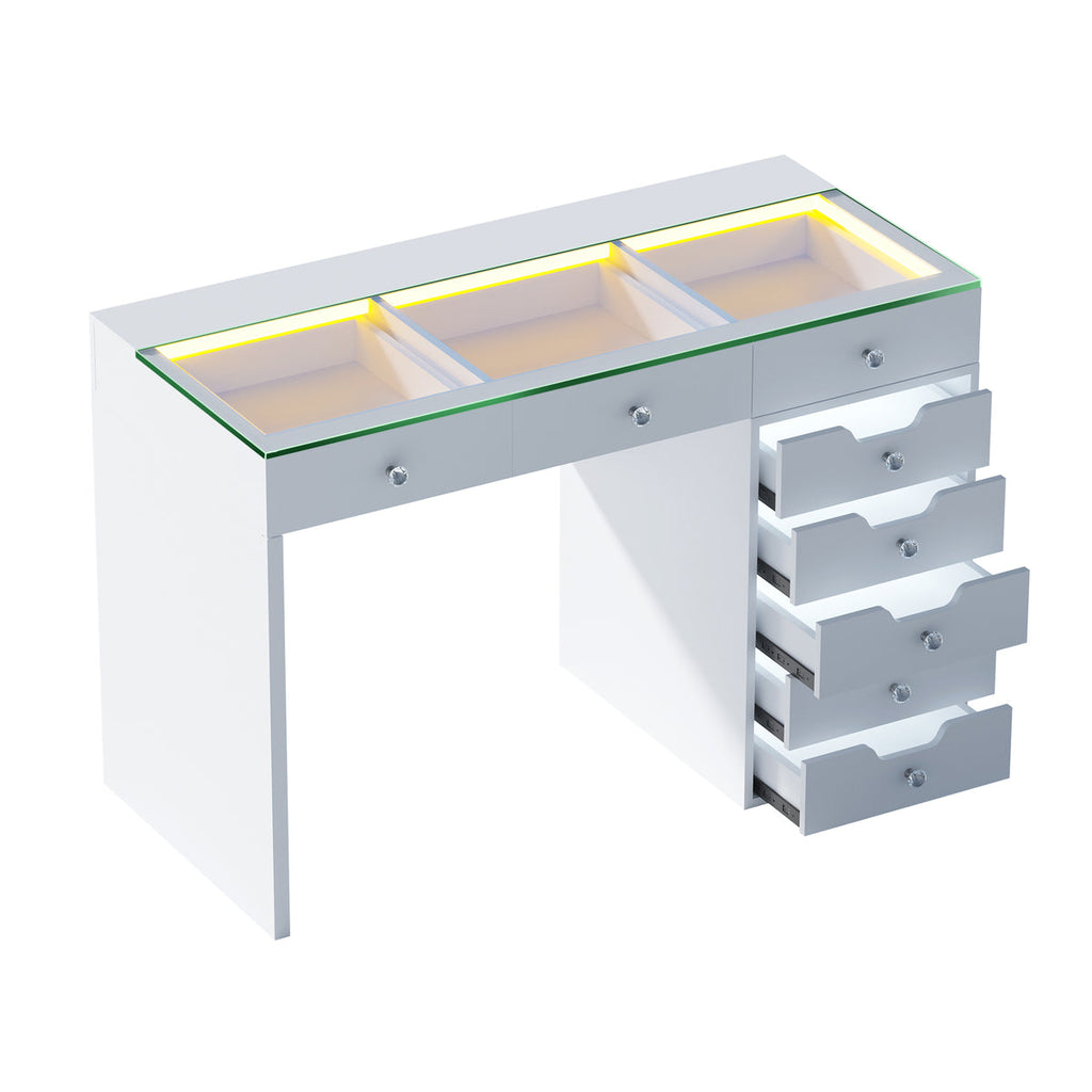 White vanity table with glass top and drawers on a white background