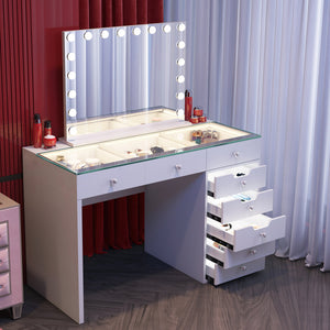 Makeup vanity with mirror and drawers in a room with red and white curtains.