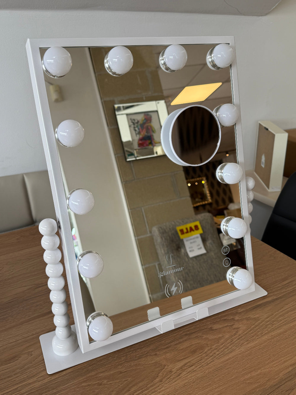 Makeup mirror with light bulbs on a wooden floor