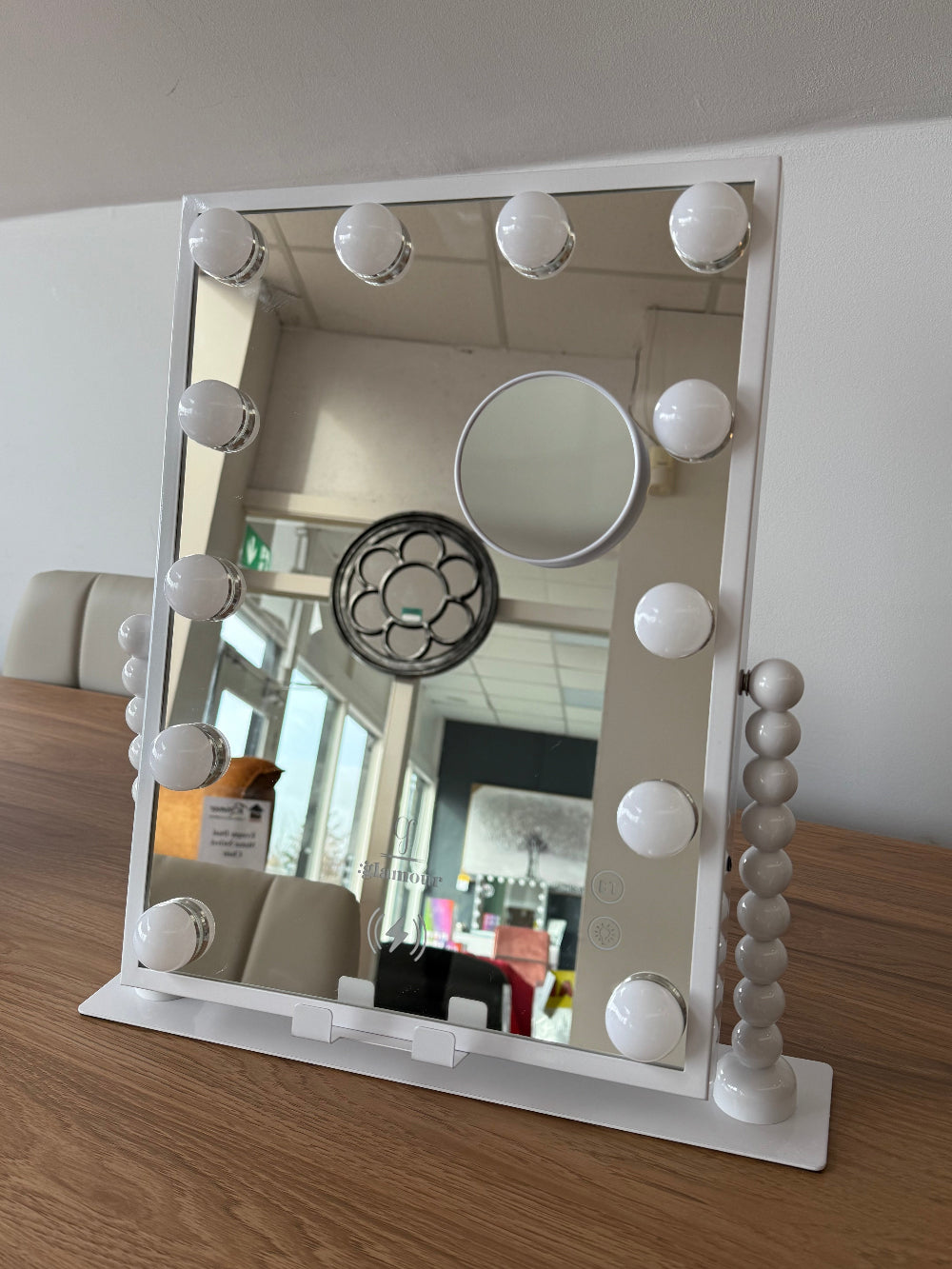 Makeup mirror with light bulbs on a wooden surface