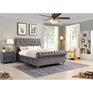 Grey upholstered bed in a well-lit bedroom with decor elements.