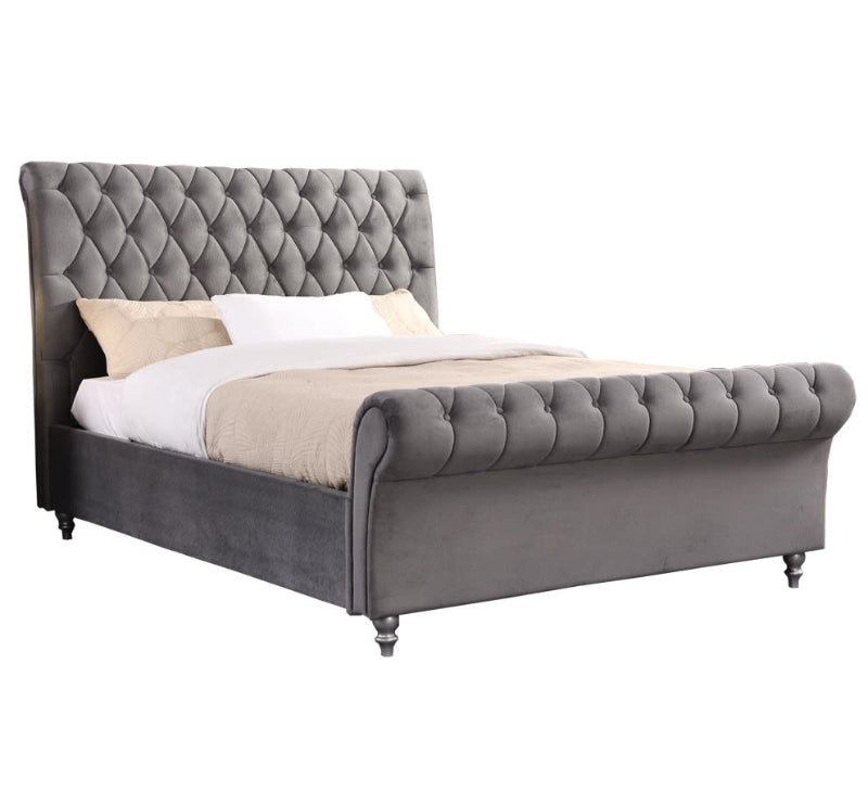 Grey upholstered bed with tufted design on a white background