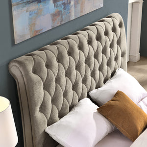 Mink tufted headboard with pillows in a bedroom setting