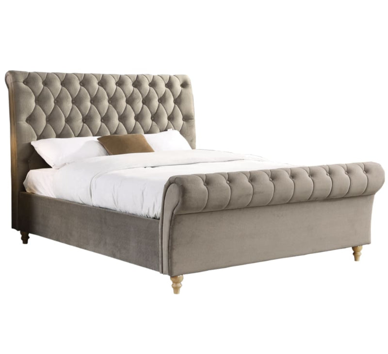 Mink upholstered bed with tufted headboard on a white background