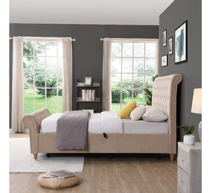 Neatly made bed in a bedroom with grey walls, large windows, and a lamp.