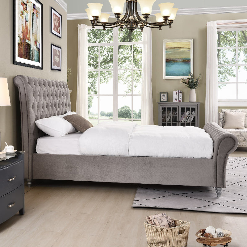 Neatly arranged bedroom with grey upholstered bed, nightstands, and decor.