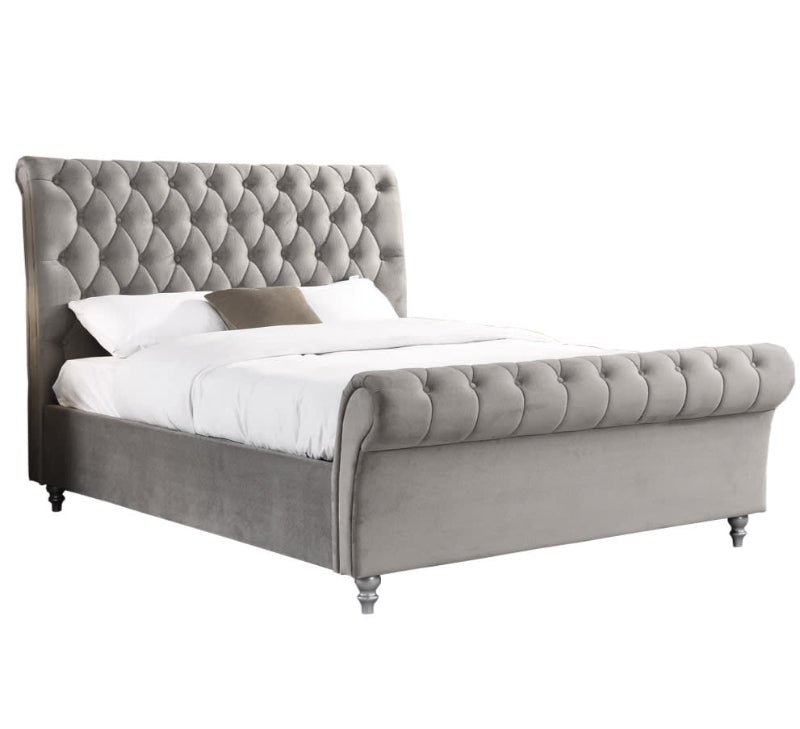 Silver tufted bed with white bedding on a white background