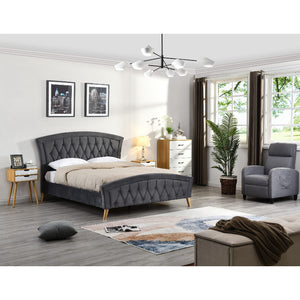 Modern bedroom with grey upholstered bed, armchair, and decor elements.