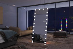 Lighted mirror in a modern living room with a cityscape view.