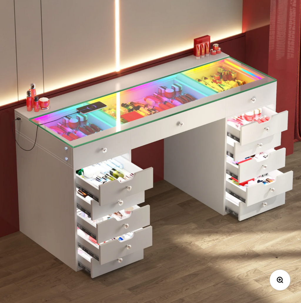 Makeup vanity with colorful top and multiple drawers on a wooden floor.