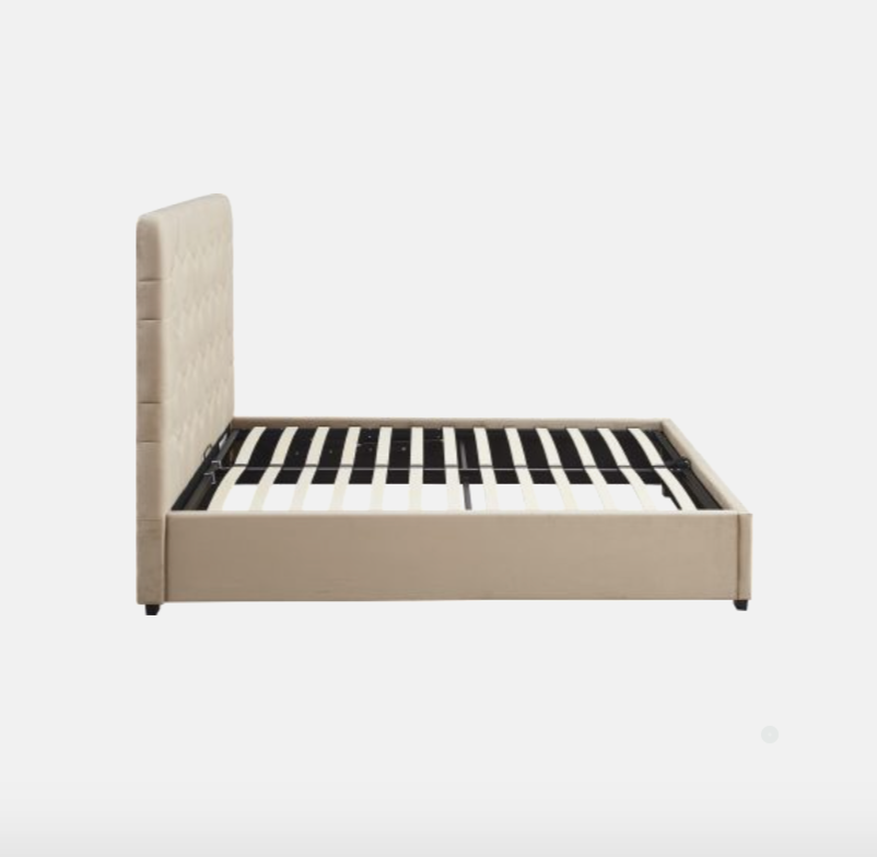 Beige upholstered bed frame with striped mattress on a white background