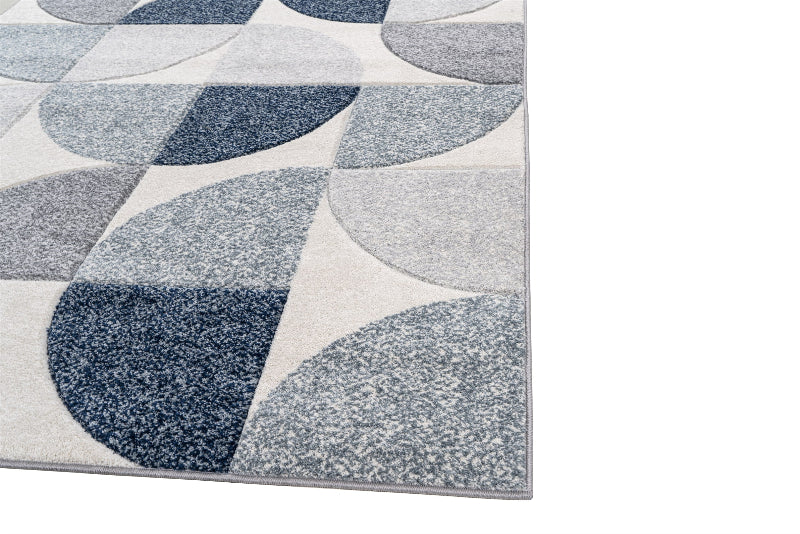 Geometric patterned rug with blue and gray shapes on a white background