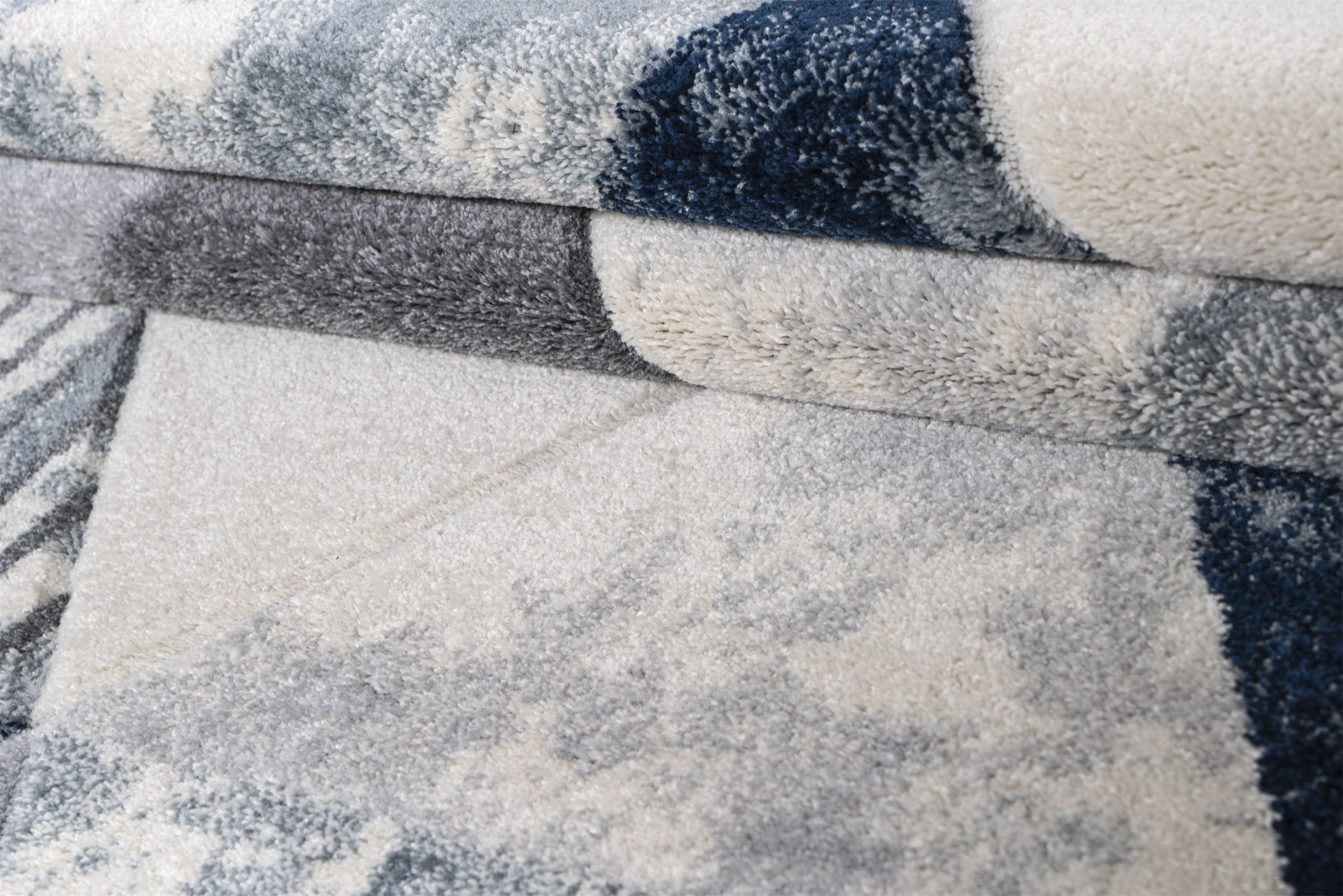 Close-up of a textured fabric with gray, white, and black colors.