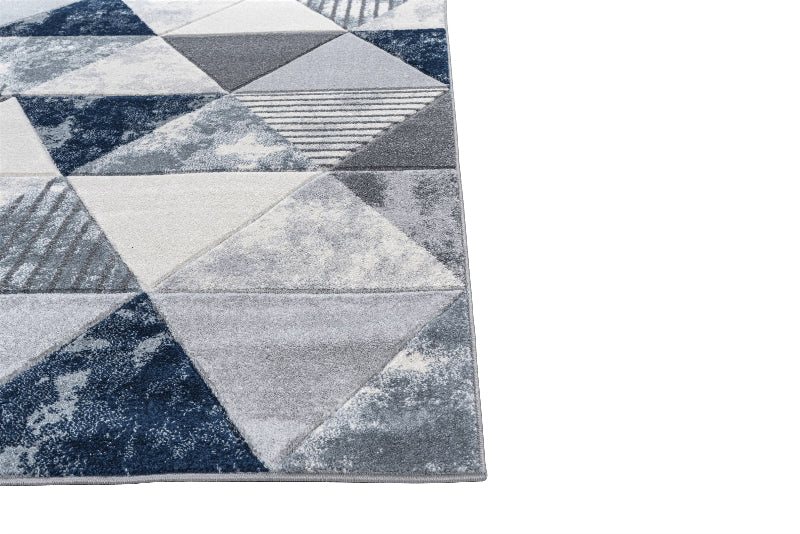 Geometric patterned rug with triangles in gray and blue on a white background