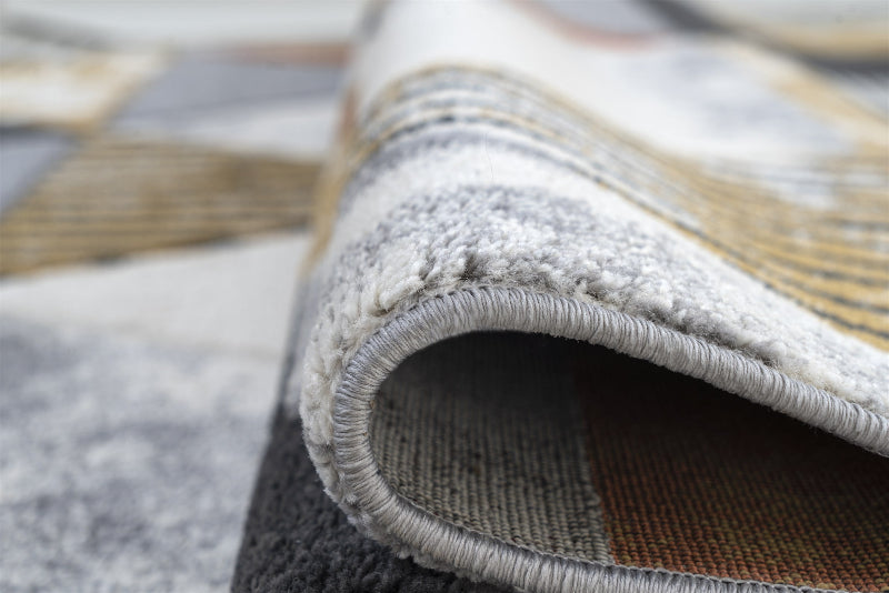 Close-up of a textured rug with a patterned edge