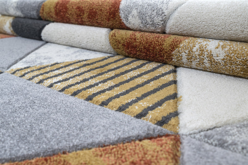 Stack of patterned rugs in various colors and textures