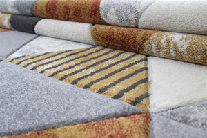 Stack of patterned rugs in various colors and textures